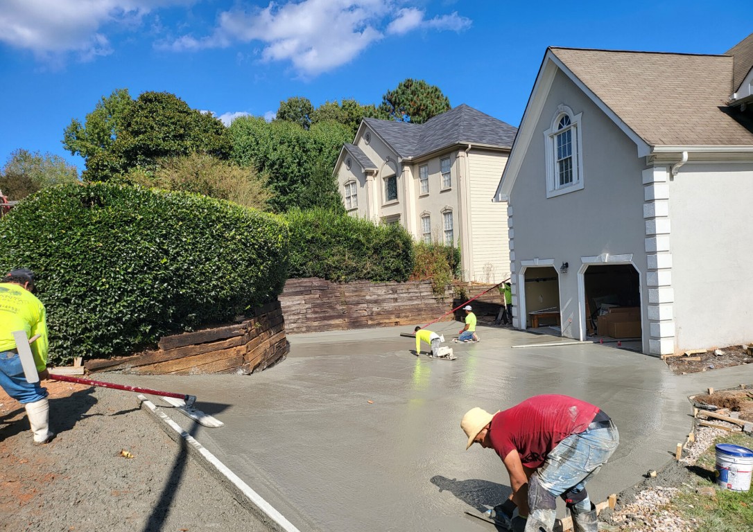 Workers finishing a new concrete driveway in Alexandria, VA